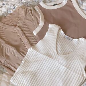 Bundle of tan, brown, and white tees